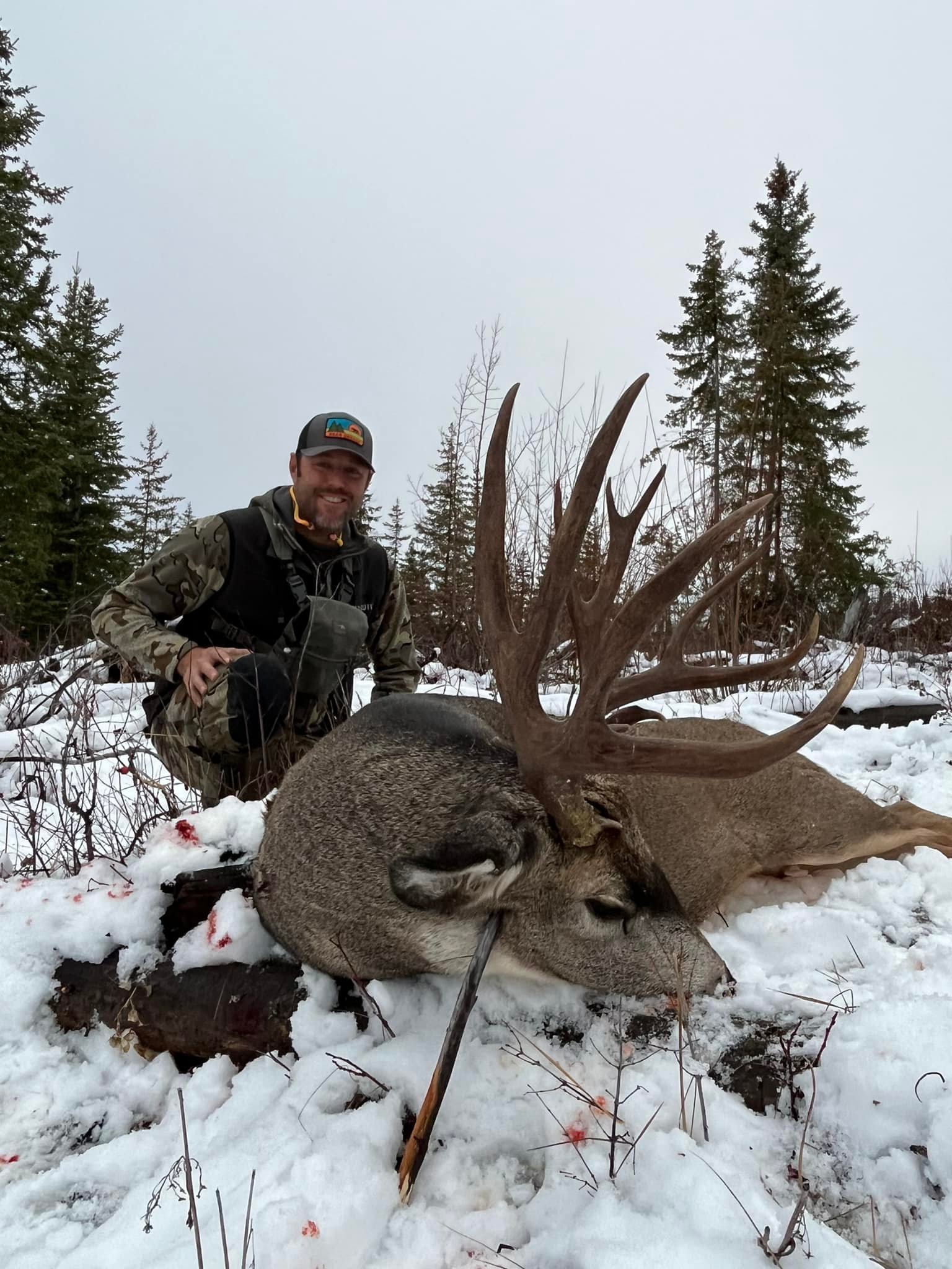 Happy hunter and guide with a harvested mule deer.