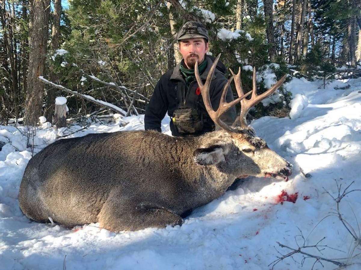 An archery hunter posing with their trophy elk.