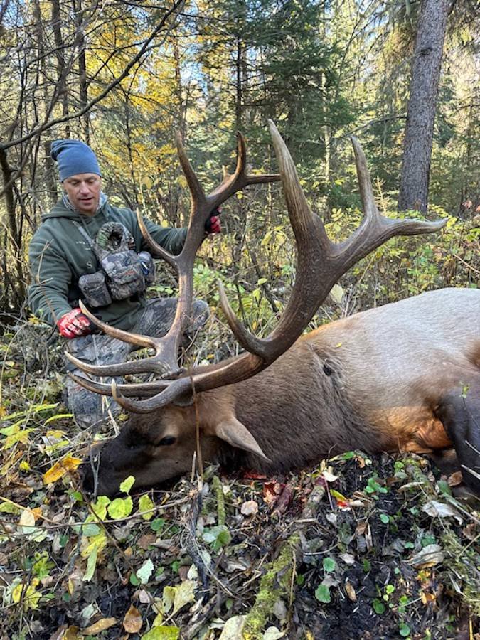 A group of smiling hunters at the end of a successful trip.